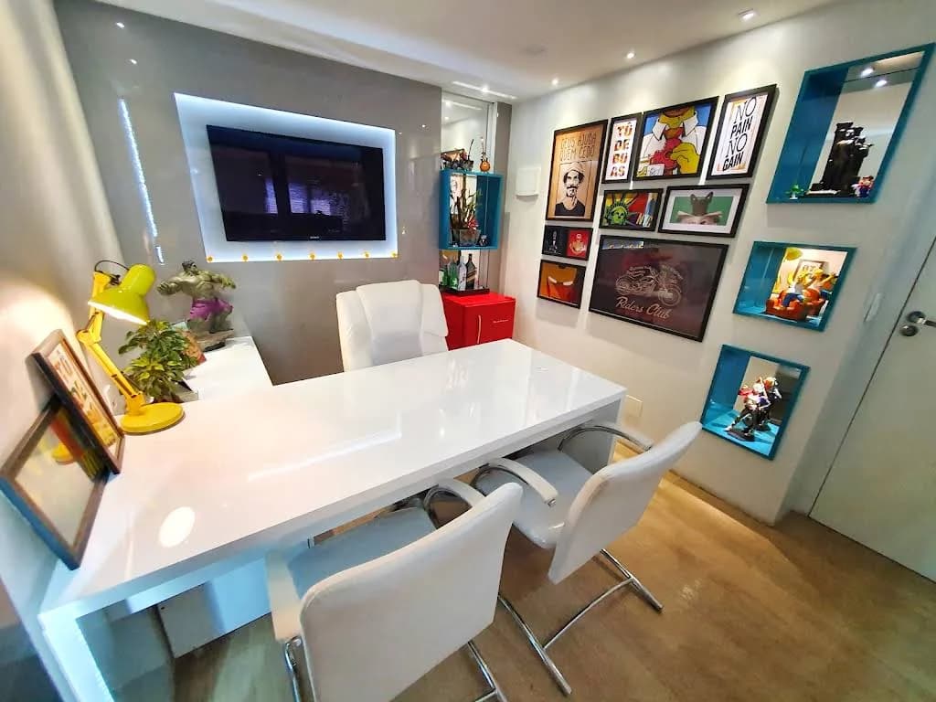 Sala de reuniões do escritório da Mix7 com mesa branca e quadros na parede